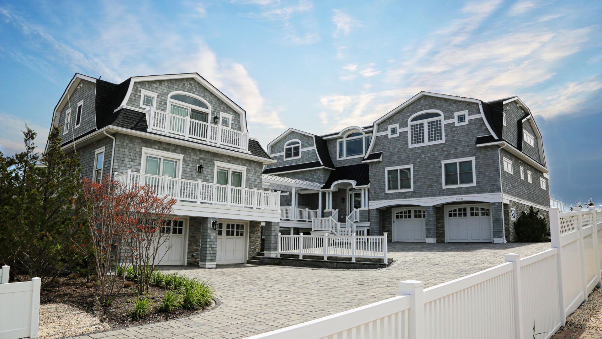 Exterior of luxury beach home boasting multiple balconies and an outdoor living space, Long Beach Island NJ