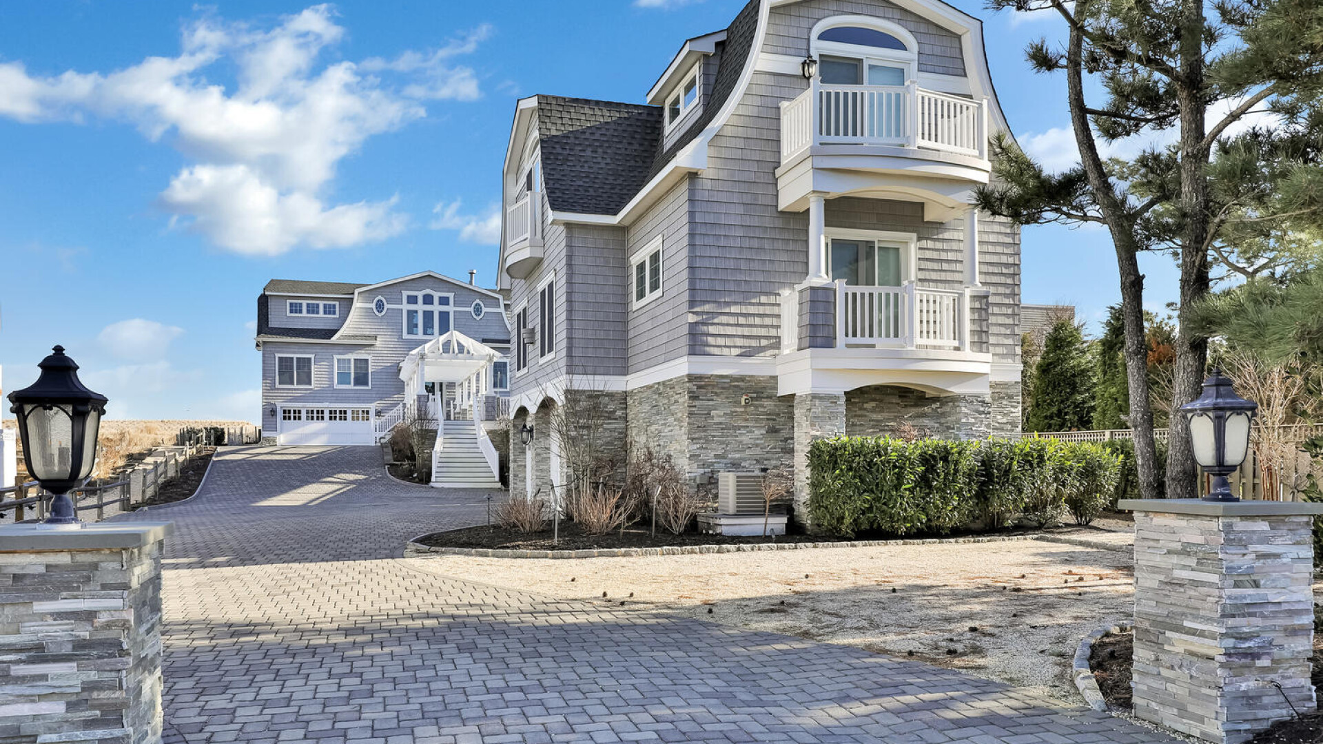 Waterside home with a sophisticated stone exterior and private balconies, Long Beach Island NJ